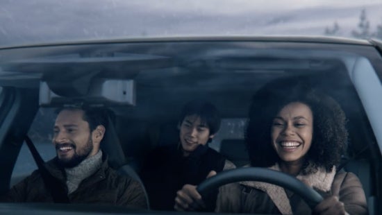 Three passengers riding in a vehicle and smiling | Crossroads Nissan Wake Forest in Wake Forest NC